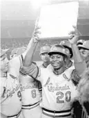  ?? AP FILE ?? Lou Brock celebrates with his Cardinals teammates after breaking Ty Cobb’s all-time stolen bases record during a game in 1977. Brock, like Aaron, died in the last year.