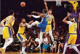  ?? Mark J. Terrill/Associated Press ?? Warriors forward Jonathan Kuminga, center, is shooting 65.4% from the field and 53.8% from 3-point range through his first two preseason appearance­s.