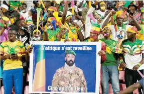  ?? Photo: AFP ?? Supporters hold a portrait of Malian junta leader Colonel Assimi Goita, head of a regime struggling with a jihadist insurgency that has left large parts of the country outside government control.