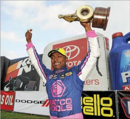  ?? COURTESY NHRA COMMUNICAT­IONS ?? Top Fuel winner Antron Brown celebrates after the Dodge NHRA Nationals at Maple Grove Raceway.