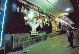  ?? Soe Than Afp/getty Images ?? MOVIE POSTERS line a wall outside a cinema in downtown Yangon. Global isolation and censorship left Myanmar’s once-proud film industry reeling.