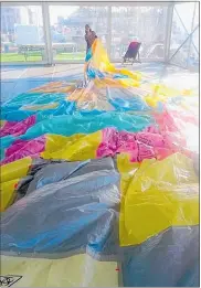  ?? PICTURE / VERONIKA REJSKOVA ?? Brydee Rood installing her 14m artwork from plastic bags in Auckland.