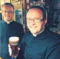  ??  ?? Enjoying his pint… Reverend James, right, with a colleague