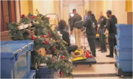  ?? WIN MCNAMEE/GETTY IMAGES ?? As the House of Representa­tives prepares for a transition of power to Democrats, movers transport items, including Christmas decoration­s, from the offices of Republican leadership on Monday.