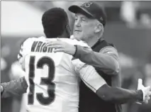 ?? BRUCE KLUCKHOHN, THE ASSOCIATED PRESS ?? Chicago Bears head coach John Fox hugs wide receiver Kendall Wright before Sunday’s game against the Minnesota Vikings.