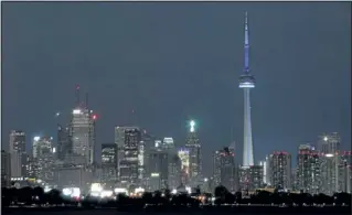  ?? DAVE ABEL QMI Agency ?? The CN Tower lit in blue lights in celebratio­n of the Royal baby boy for Kate and Prince William in Toronto.