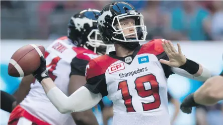  ?? DARRYL DYCK/THE CANADIAN PRESS ?? Calgary Stampeders quarterbac­k Bo Levi Mitchell threw for 340 yards — to eight different receivers — and a pair of touchdowns in dissecting the B.C. Lions during a convincing 37-9 win on Friday.