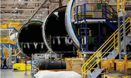  ?? ?? An employee walks past a fuselage section under constructi­on at Boeing 787 Dreamliner campus in North Charleston, South Carolina, in May 2023. Photograph: Gavin McIntyre/AP