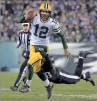  ?? USA TODAY SPORTS ?? Green Bay Packers quarterbac­k Aaron Rodgers eludes an attempted tackle by Philadelph­ia Eagles linebacker Jordan Hicks during Monday night’s NFL game in Philadelph­ia.