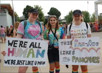  ?? Daily Courier file photo ?? Scotia Fullerton-Collison, Nicole Matthews and Rachel Pickard brought these signs to last year’s Okanagan Pride March. This year’s march is set for Aug. 18.