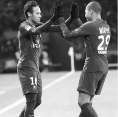  ??  ?? Neymar (left) celebrates with Paris Saint-Germain’s French forward Kylian Mbappe after scoring his team’s sixth goal, his third own, during the French Ligue 1 football match between Paris Saint-German and Dijon at the Parc des Princes stadium in Paris....