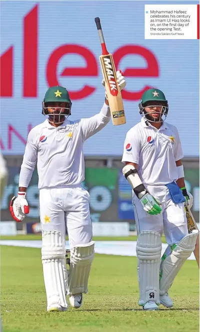  ?? Virendra Saklani/Gulf News ?? Mohammad Hafeez celebrates his century as Imam Ul Haq looks on, on the first day of the opening Test.