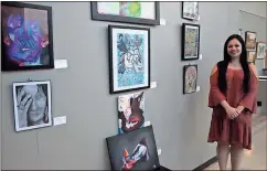  ?? Kevin Myrick / Standard Journal ?? Kasi Price, a Rockmart senior, stands with her work on display at the Cedartown Performing Arts Center at their art show gala on Saturday. She calls her work “happy, hippy, trippy art.”