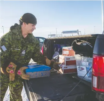  ?? LIAM RICHARDS ?? Military member Joel Pedersen, who is also a retired Saskatoon Police Service member, moves football equipment in the back of his truck on Wednesday prior to loading a small plane at the Aero Centre and flying to Canoe Lake to deliver the gear to the First Nation and its football program.