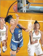  ?? [BRYAN TERRY/THE OKLAHOMAN] ?? Putnam City West's Alyssa Parmer, center, goes to the basket between Midwest City's Taliyah Anderson, left, and Dejahnar Chatman during a girls high school basketball game on Tuesday night in Midwest City.