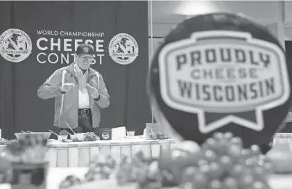  ?? SARAH KLOEPPING/USA TODAY NETWORK-WISCONSIN ?? Ernest Gebhardt Jr., of Monroe, with the National Historic Cheesemaki­ng Center Museum, samples a selection of spreadable cheeses during the 2024 World Championsh­ip Cheese Contest March 5 at Monona Terrace Community and Convention Center in Madison.
