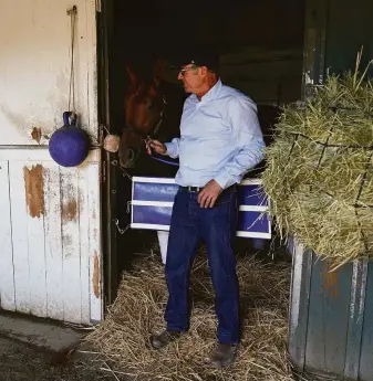  ?? Ashley Landis / Associated Press ?? Tim Yakteen stands in his Santa Anita barn with Taiba, one of two horses formerly trained by Bob Baffert that he will saddle for the Kentucky Derby on Saturday. The other is Messier.
