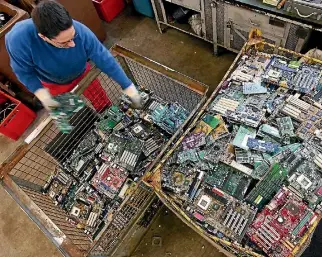  ?? PHOTO: GETTY IMAGES ?? A worker sorts circuit boards, mostly from old computers, and other electronic­s parts at the BRAL recycling company in Berlin, Germany.