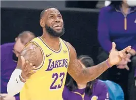  ?? MARCIOJOSE SANCHEZ/AP ?? LeBron James and his Lakers teammates received their championsh­ip rings Tuesday night, but then fell to the Clippers 116-109 in an opener for both teams.