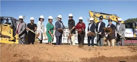  ?? STAFF PHOTO BY MATT HAMILTON ?? Officials turn the first shovels of soil during the groundbrea­king ceremony Tuesday at Tyner Academy.