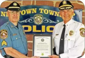  ??  ?? Displaying the accreditat­ion certificat­e are Police Chief Henry Pasqualini and Sergeant Mark Pentz, a 29-year veteran of the department and accreditat­ion manager.