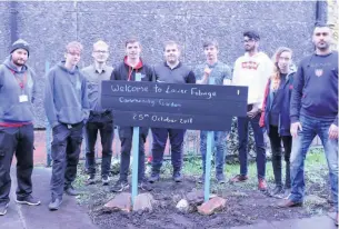  ??  ?? ●●Volunteers at the Community Base community carden in Lower Falinge