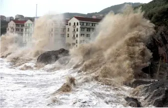  ??  ?? Waves caused by typhoon Maria batter the coast near Wenling, east China’s Zhejiang province. — AFP photo