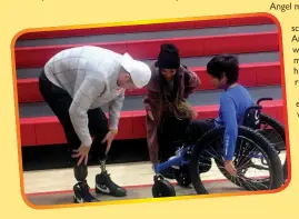  ?? Photo courtesy Northwest Arkansas Democrat-Gazette/TRACY NEAL ?? Eleven year old Angel Figueroa, a 6th grader at Greer Lingle Middle School talks with Hunter Woodhall, a Paralympia­n, and his wife, Tara Davis Woodhall, Tuesday after a school assembly. Angel is wheelchair bound, and a member of the Sixth Grade Running Club received a new custom wheelchair to aid him in the activity.