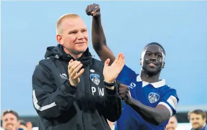  ?? Photo / Getty Images ?? Pete Wild celebrates with his players after Oldham’s FA Cup win at Fulham yesterday.