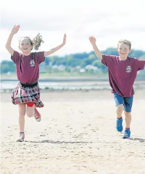  ??  ?? Darci Reid and her brother Eden at Monifieth beach.