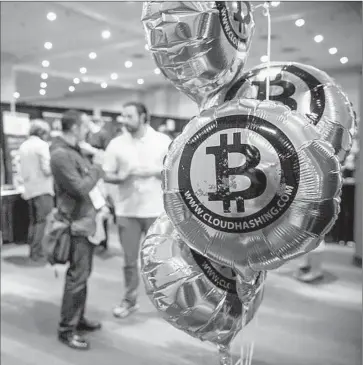  ?? Andrew Burton
Getty Images ?? A BITCOIN convention in New York. Blockchain is the system that bitcoin inventors devised; to understand how it works requires dedicated study, but non-specialist­s might think of it as a publicly viewable spreadshee­t.