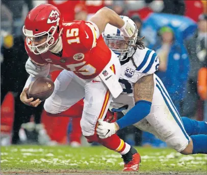  ?? [CHARLIE RIEDEL/THE ASSOCIATED PRESS] ?? Chiefs quarterbac­k Patrick Mahomes is brought down by Colts defensive end Margus Hunt as Mahomes runs for a first down in the first half, helping Kansas City take a 24-7 lead.