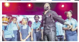  ?? ?? Ky-mani Marley performs with children of Bob Marley Primary and Junior High on the charity concert stage.