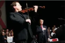  ?? AP PHOTO/EVAN VUCCI ?? President Donald Trump listens as Cuban born violinist Luis Haza plays the national anthem during a speech on Cuba policy Friday in Miami.