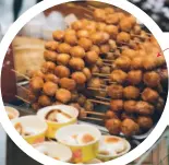  ??  ?? The rice balls from the Jinli street market are drizzled in sweet syrup and sprinkled with sesame seeds.