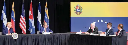  ?? PEDRO PORTAL pportal@miamiheral­d.com ?? From left, President Donald Trump and Congressma­n Mario Diaz-Balart, R-S. Fla., and listen to Venezuelan and Cuban exiles, including Orlando Gutierrez-Boronat, third from right, at the Jesus Worship Center in Doral on Friday.