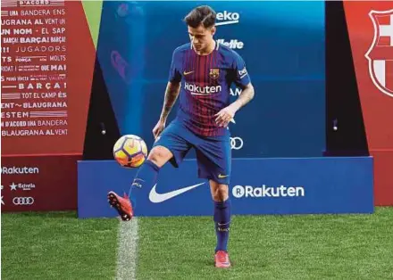  ??  ?? Barcelona's new signing Philippe Coutinho juggles a ball during his presentati­on at Camp Nou on Monday. REUTERS PIC