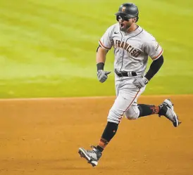  ?? Tony Gutierrez / Associated Press ?? The Giants’ Mike Tauchman rounds second base after hitting a grand slam during the eighth inning in Arlington, Texas.