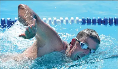  ?? Buy these photos at YumaSun.com PHOTOS BY RANDY HOEFT/YUMA SUN ?? KOFA SWIM COACH MARK VAN VOORST SWIMS the 50-yard freestyle during a race Monday morning against Yuma Sun sports editor Grady Garrett at Valley Aquatic Center. Van Voorst won by 13 seconds.