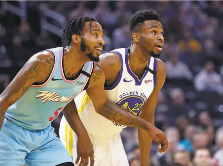  ?? Scott Strazzante / The Chronicle ?? The Warriors’ Andrew Wiggins (right), acquired from the Timberwolv­es last week, scored 18 points against Miami on Monday.