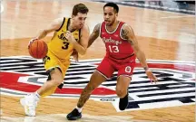  ??  ?? Iowa’s Jordan (left) brings the ball upcourt against Ohio State’s C.J. Walker during Sunday’s clash in Columbus. The Buckeyes, who have lost three straight, host Illinois on Saturday.