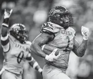  ?? Eric Gay / Associated Press ?? UTSA’s Charles Wiley returns a fumble for a touchdown against Lamar during the first half.