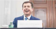  ?? STEFANI REYNOLDS/GETTY ?? Pete Buttigieg, the nominee for transporta­tion secretary under President Joe Biden, smiles during his Senate confirmati­on hearing Thursday.