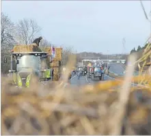  ?? Picture: AP ?? Farmers block a highway near Paris’ main airport with hay bales near Roissy-en-France, north of Paris on Monday.