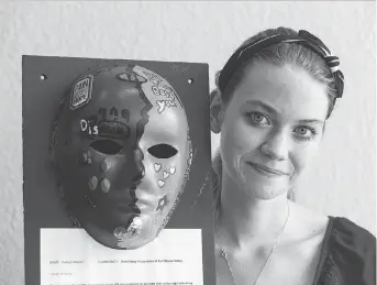  ?? PHOTOS: ERROL MCGIHON ?? Katelyn-Marie Irvine with the mask artistical­ly representi­ng her personal journey. Her mask has two faces: a dark side marked by large tears, the other a radiant sky-blue — Irvine’s favourite colour.