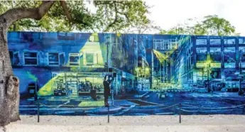  ?? RENÉE S. SUEN PHOTOS ?? Urban landscape stencil muralist Logan Hicks’ 12-by-2-metre nightscape stands out in Wynwood Garden.