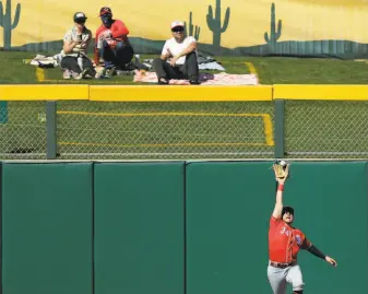  ?? Carlos Avila Gonzalez / The Chronicle ?? Fans can still get close to players like the Reds’ Mark Payton, snagging a fly against the A’s.