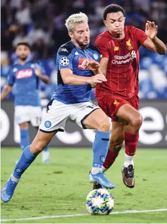  ?? File/AFP ?? Napoli's Belgian forward Dries Mertens, left, challenges Liverpool's English defender Trent Alexander-Arnold.