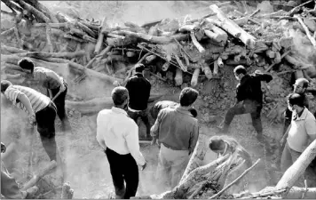  ?? — Photo by The Associated Press ?? Iranians search the ruins of buildings at the village of Bajebaj near the city of Varzaqan in northweste­rn Iran Sunday after Saturday’s earthquake. Twin earthquake­s have killed at least 250 people and injured more than 2,000, Iranian state television...