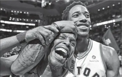  ?? CP PHOTO ?? Toronto Raptors’ Kyle Lowry, left, and DeMar DeRozan celebrate after defeating the Milwaukee Bucks in NBA action in Toronto on Monday, Jan. 1, 2018.